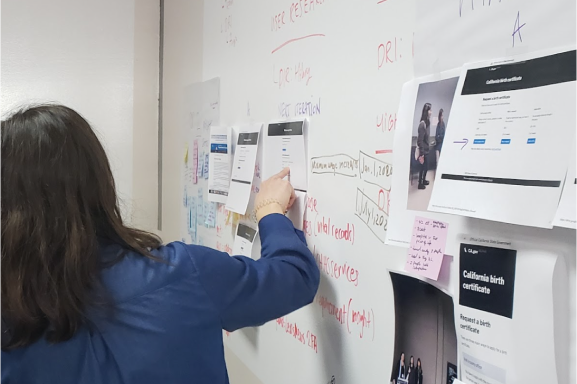 Person walking through a whiteboard showing the design process