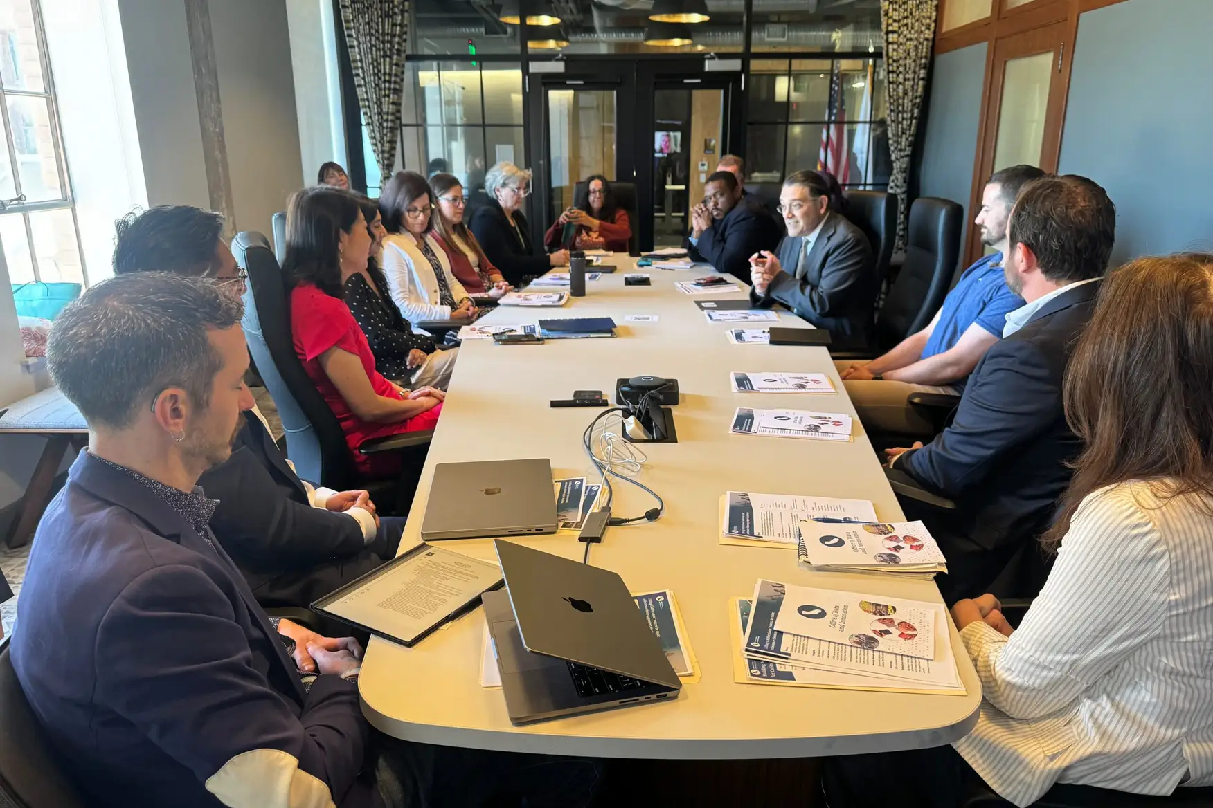 Leaders and staff from the U.S. Census Bureau and the State of California in a meeting room, discussing issues at a conference table