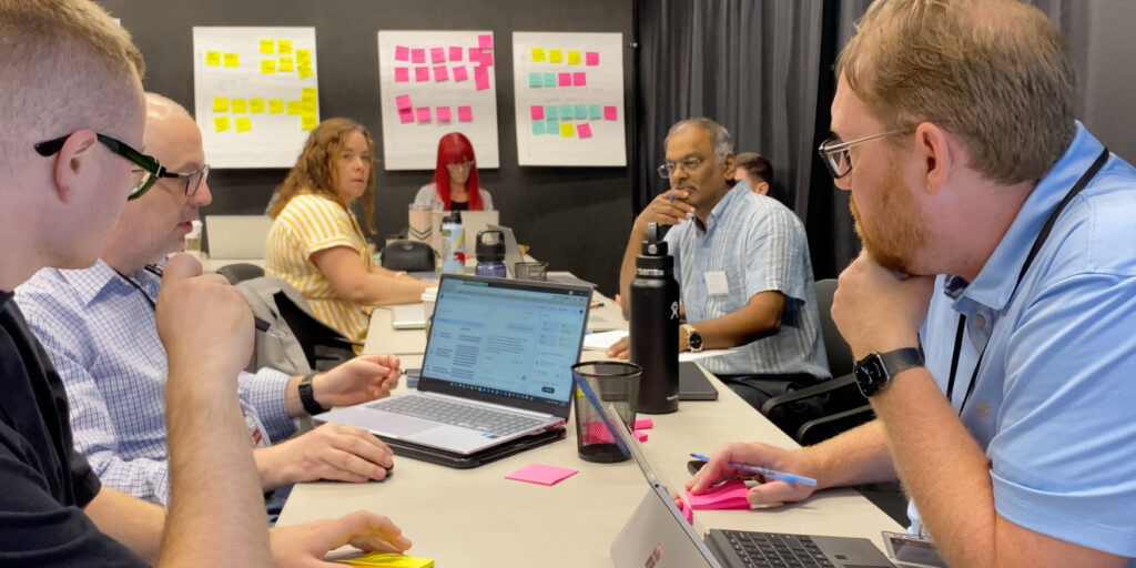 Governor's Innovation Fellows thinking about a process at a table